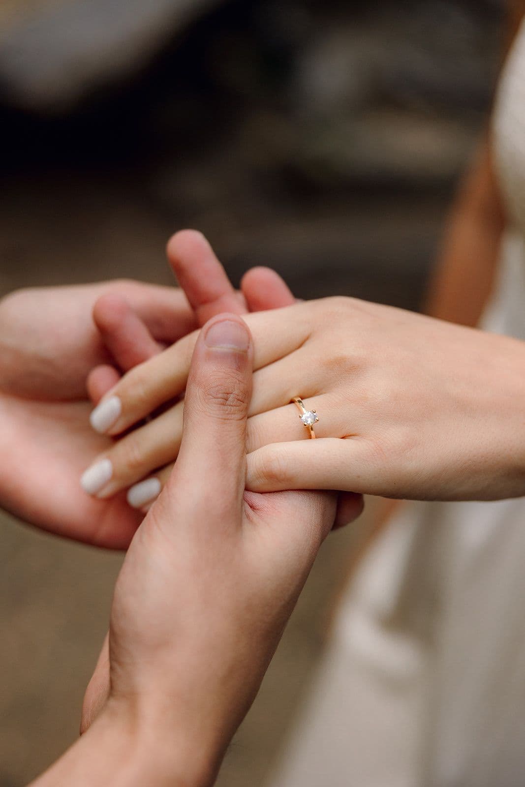 Jennifer and Christian’s hands, with the engagement ring